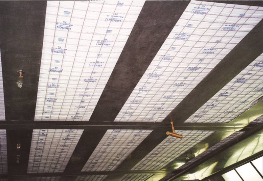 Insulated ceiling panels with grid pattern and visible water pipes.